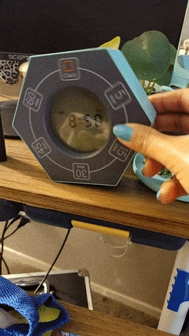 gif of a reviewer turning the clock on its side to change the minute interval