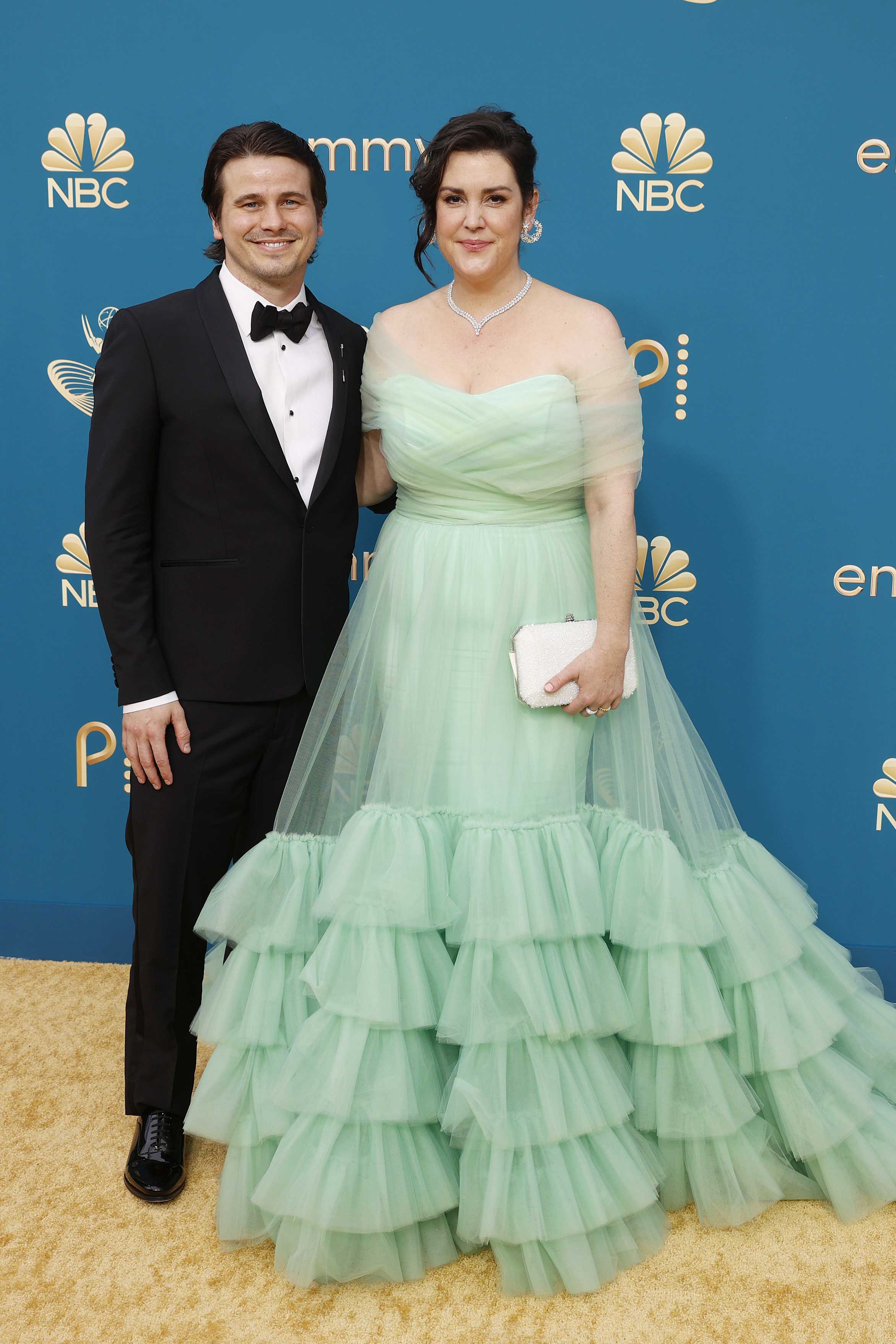 Melanie Lynskey in a pastel green poufy gown and Jason Ritter in a tux
