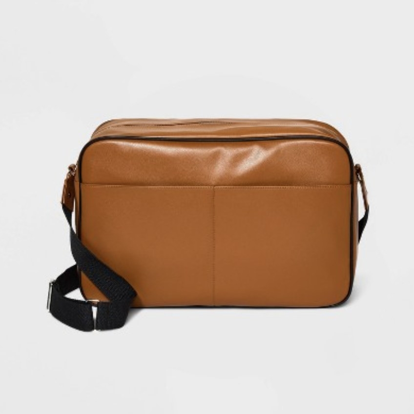 The brown faux leather back has two exterior pockets and an adjustable black strap