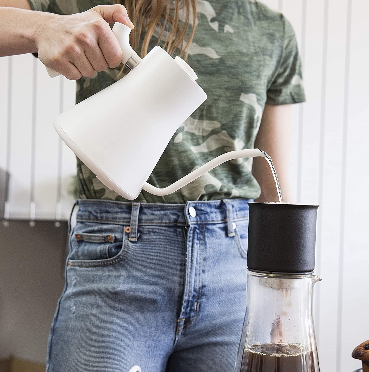 A person using the kettle to make pour-over coffee