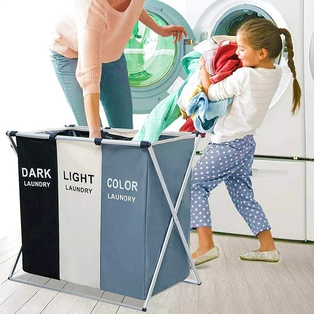 Mom and daughter taking clothes out of laundry hamper