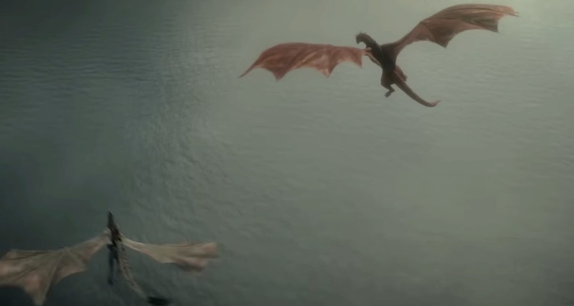 Two dragons fly over water