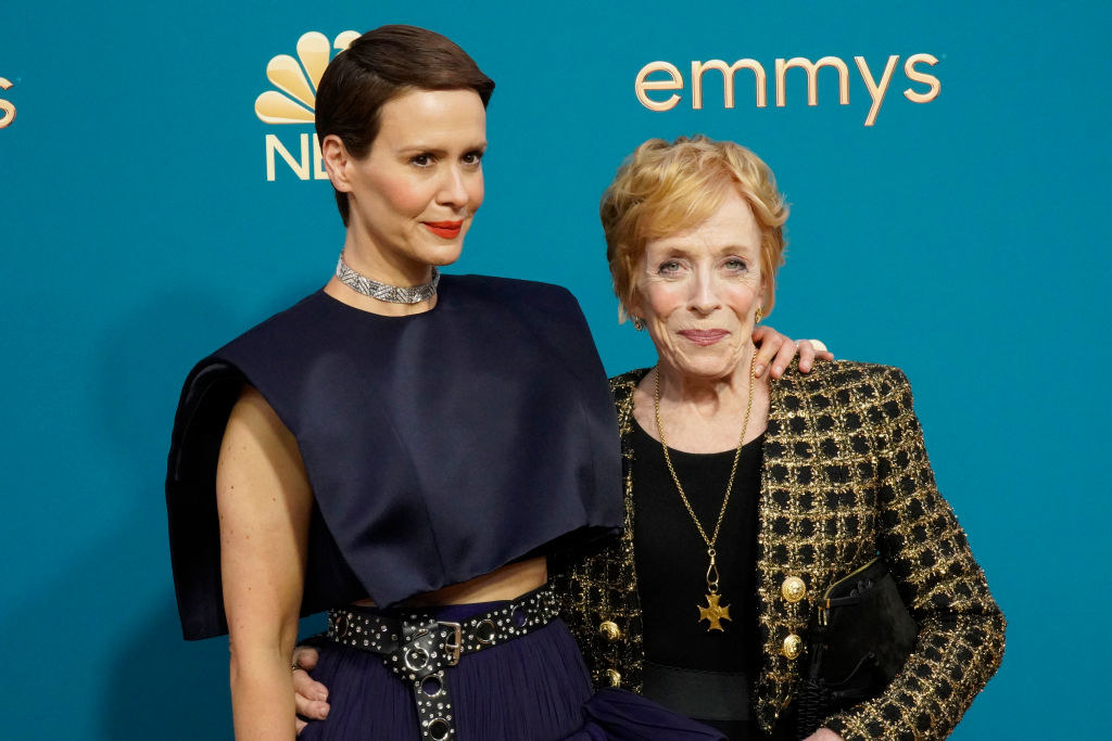 Sarah Paulson in a navy blue crop top and skirt and Holland Taylor in a gold and black jacket