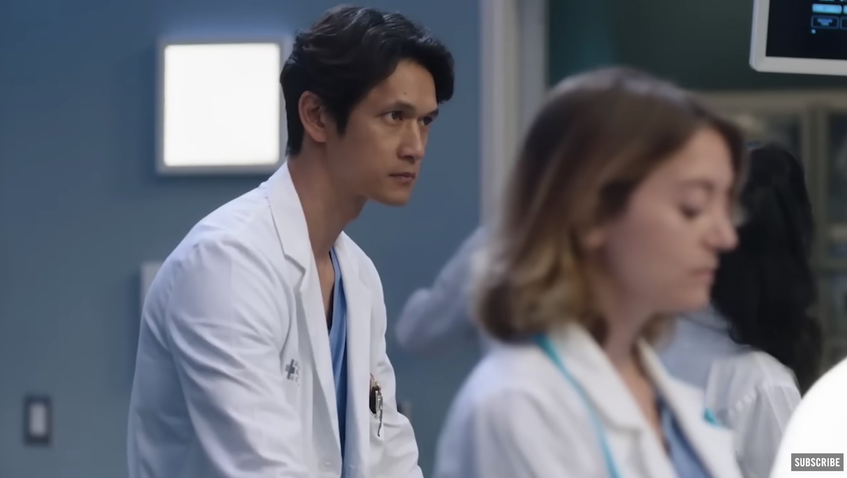Harry Shum Jr. on the set of Grey&#x27;s Anatomy wearing scrubs and a lab coat