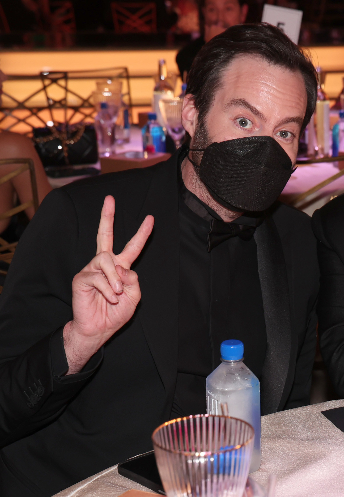 Bill Hader giving the peace sign and wearing a mask