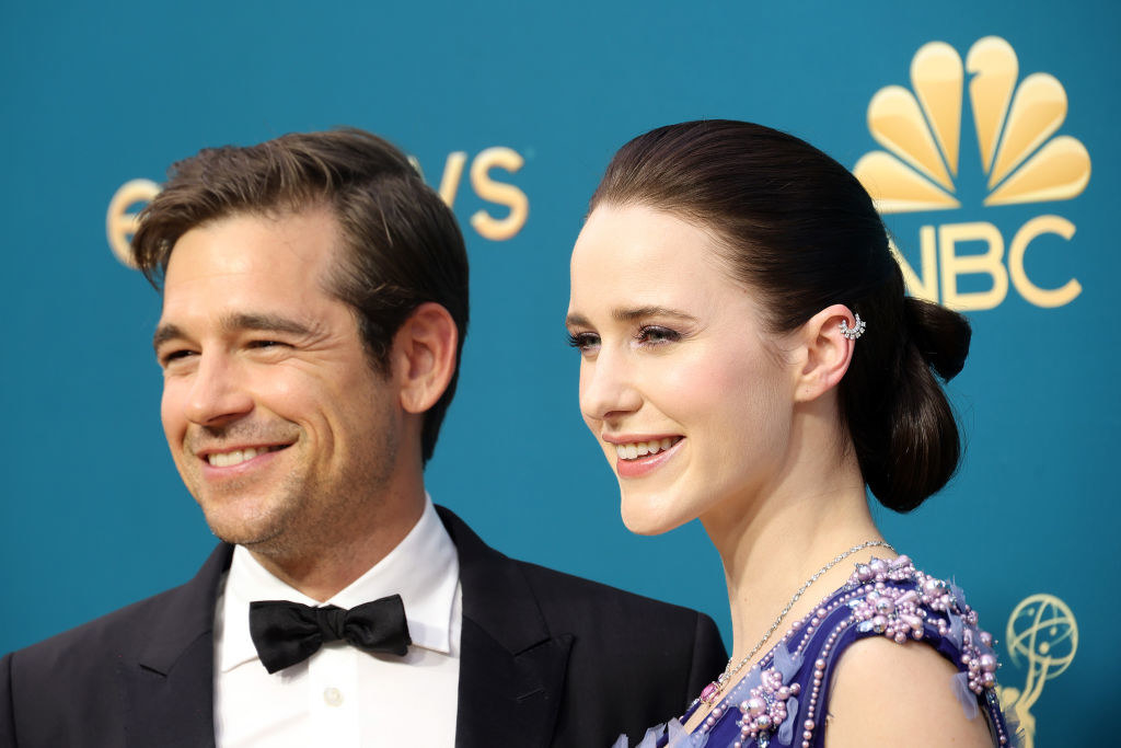 closeup of Jason Ralph in a tux and Rachel Brosnahan in a blue and lavender sequined dress