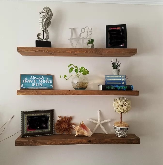 A reviewer&#x27;s image of the wooden floating shelves