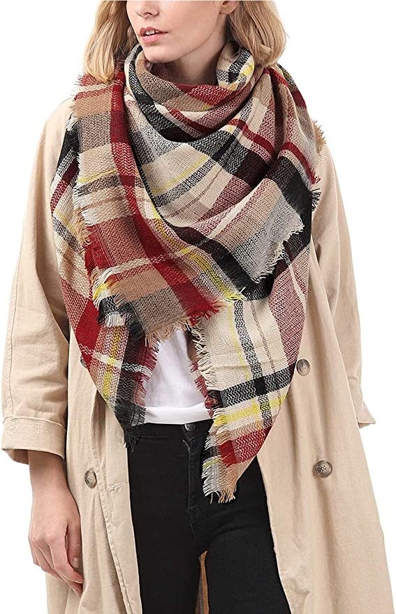 a model wearing the pink and brown plaid scarf