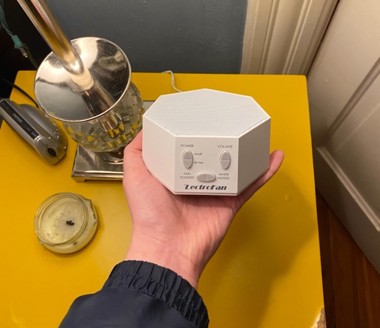 Reviewer holding the white noise machine