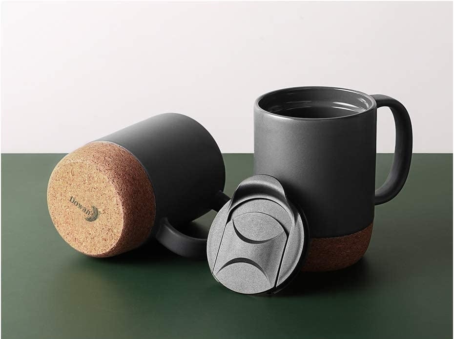 two matte grey coffee mugs with lids