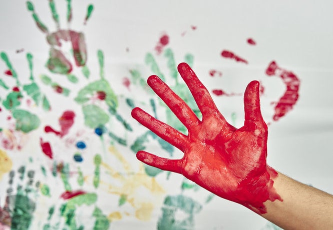 A hand covered in paint