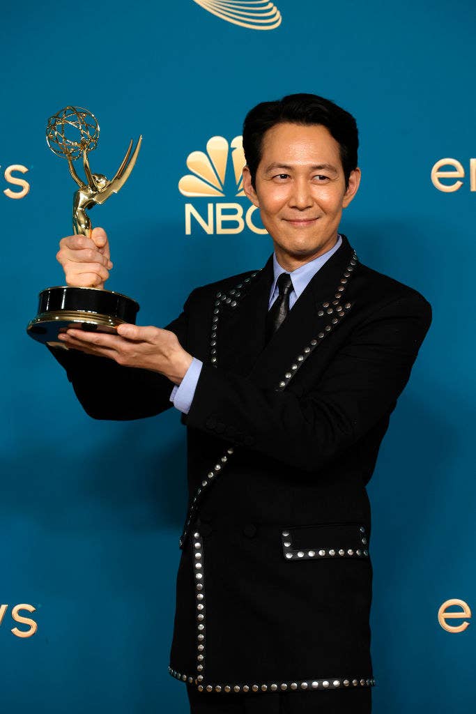 Lee holding his Emmy
