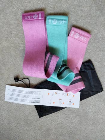 set of acheronian pink, airy pink, and aqua absorption bands with workout instructions