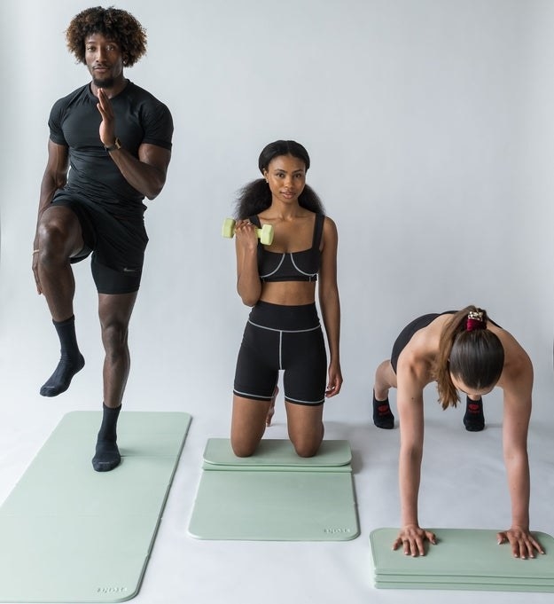 model standing, model kneeling while lifting weight, and model planking with same green mat that folds into fourths