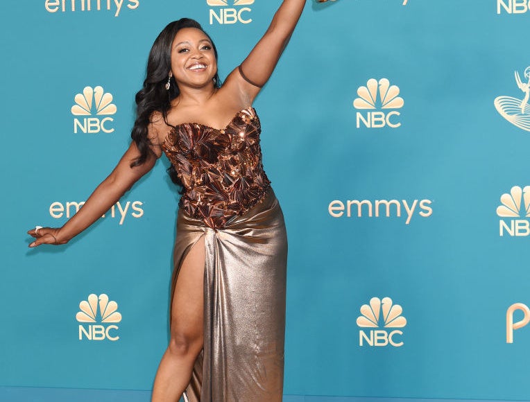 Quinta Brunson holding her Emmy