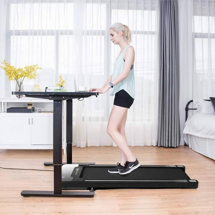 a person using the treadmill while working at a desk