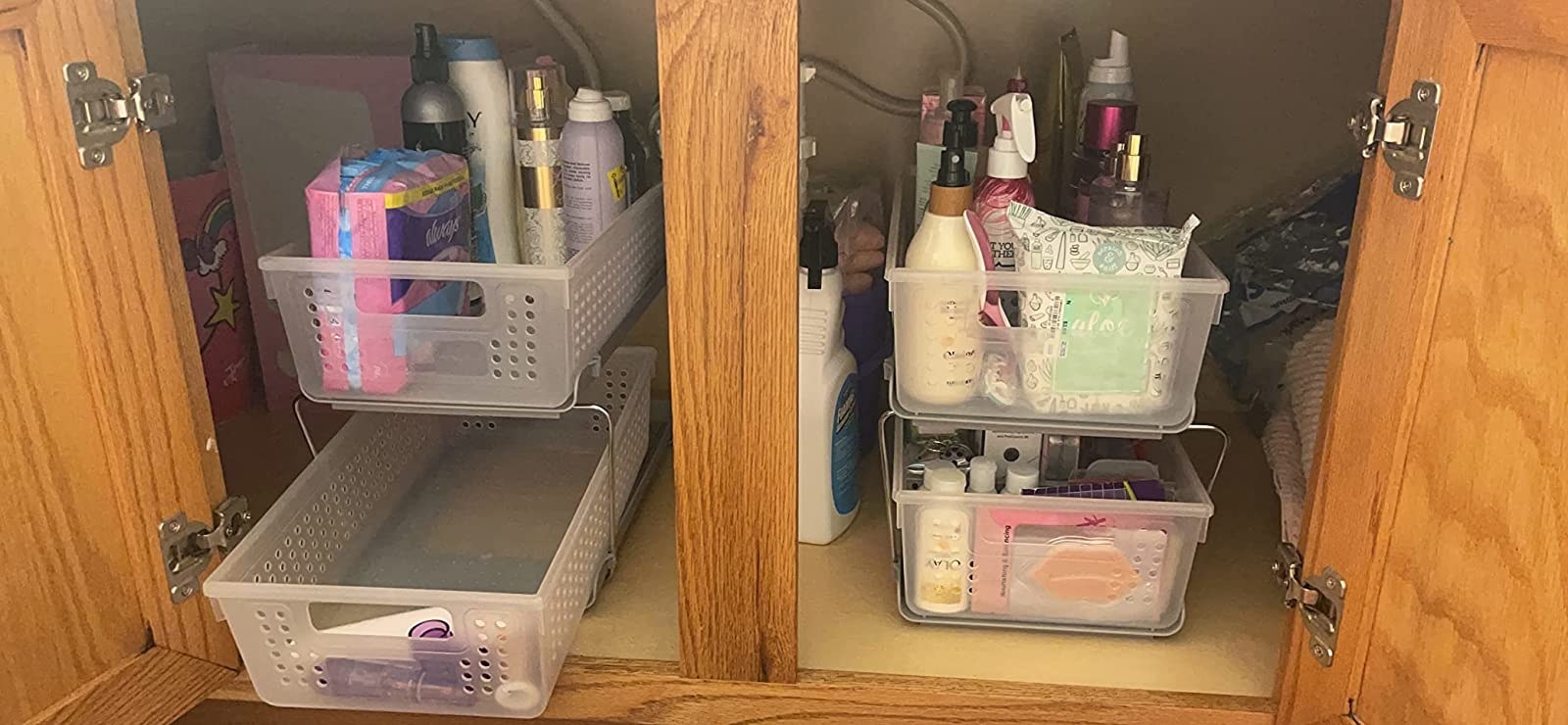 reviewer image of a pair of cabinet organizers under a bathroom sink