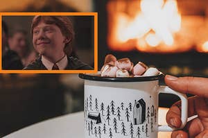 A close up of Ron Weasley as he smiles and a hand holds a hot chocolate in front of a fire