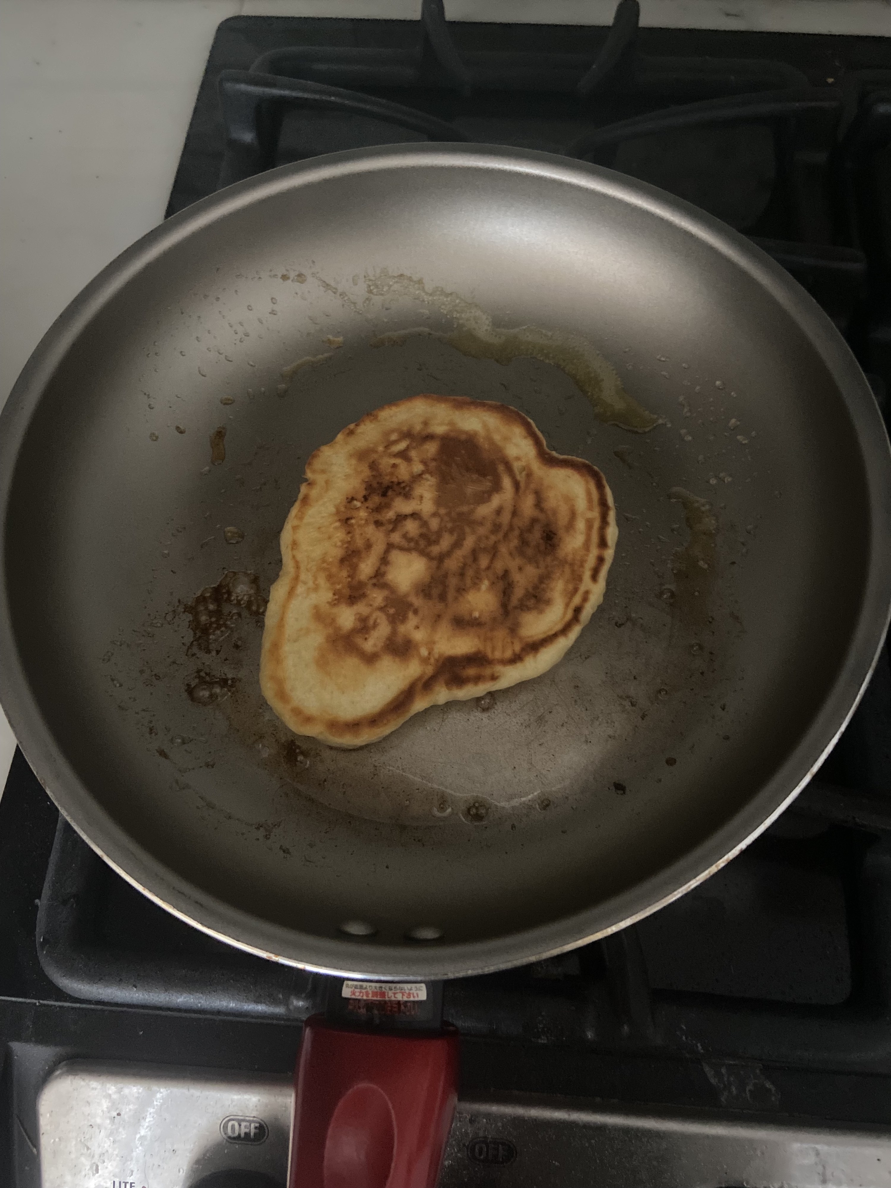 The pancake has an odd shape and looks a bit burned in the middle