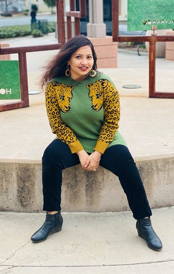 image of reviewer wearing the army green pullover sweater