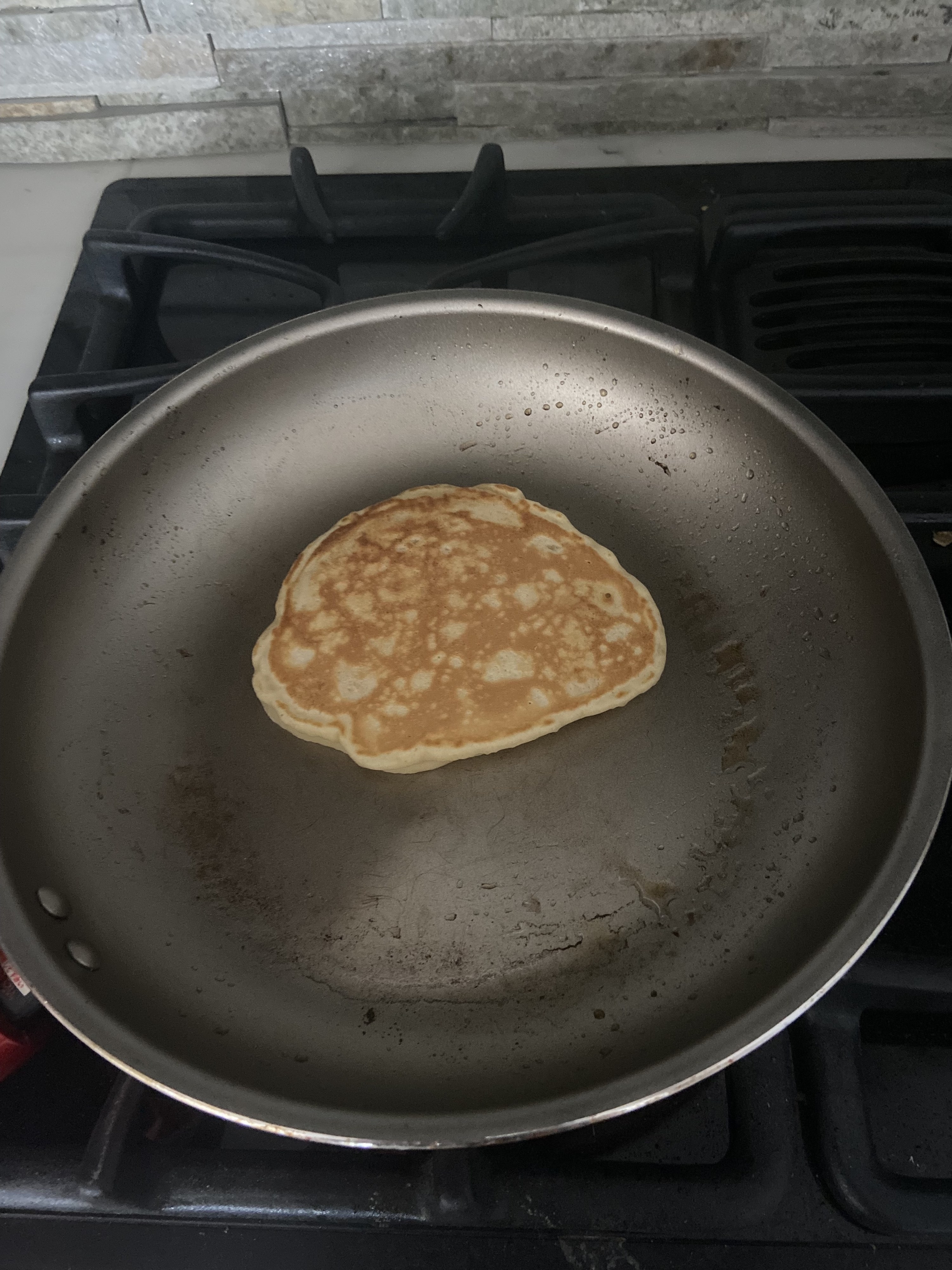 The second pancake has a smoother shape and a consistent golden brown color