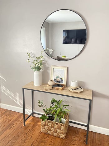 Reviewer pic of the skinny table with wood top and black legs in the entryway