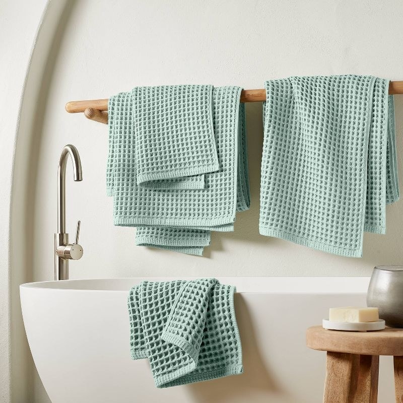 The mint colored towel set in a bathroom