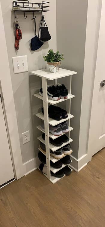 reviewer image of the tiered tower holding seven pairs of shoes