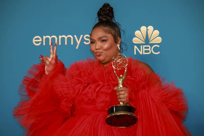 Lizzo posing for a photo with her Emmy