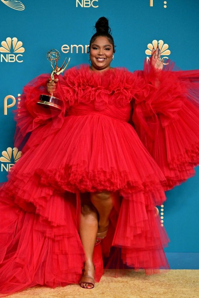 Lizzo smiling with her Emmy