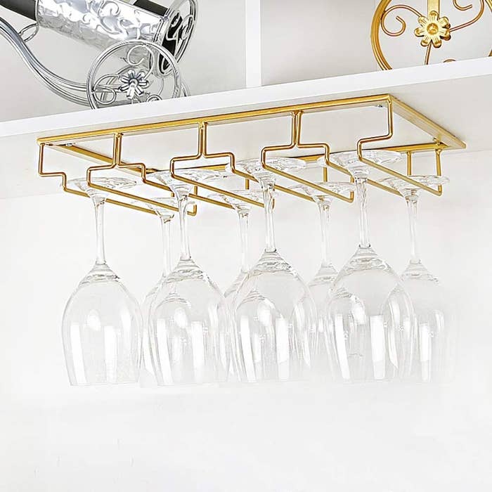 a set of wine glasses hung on the undermounted rack