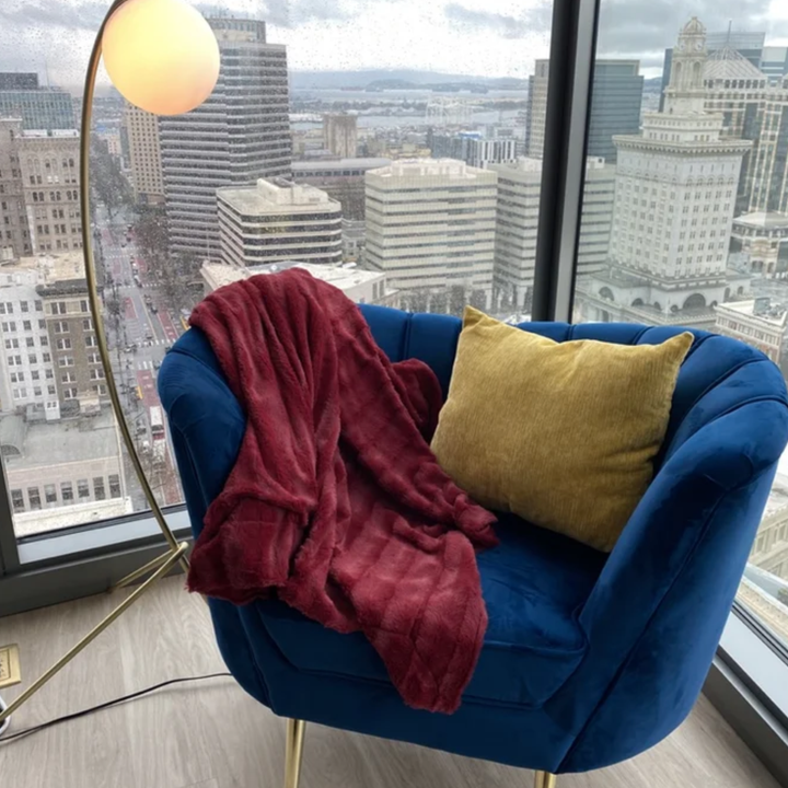 the red blanket on a blue chair