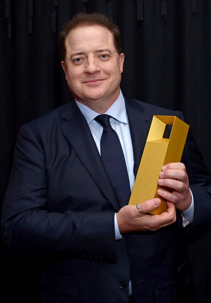 Brandan Fraser holding an award