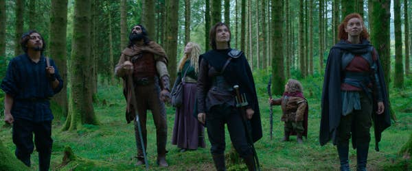 people in medieval-style clothing in the woods