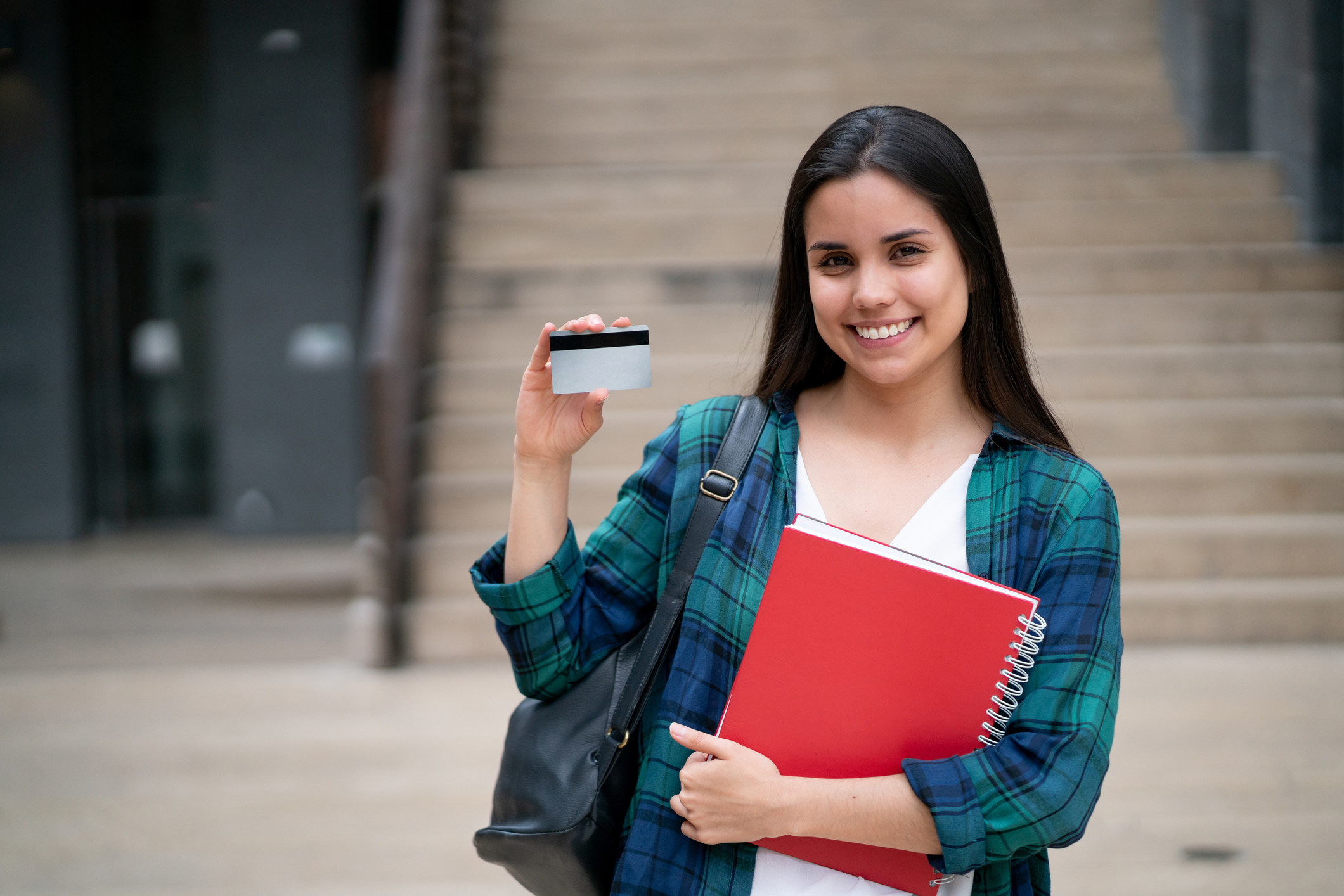 student holding a notebook