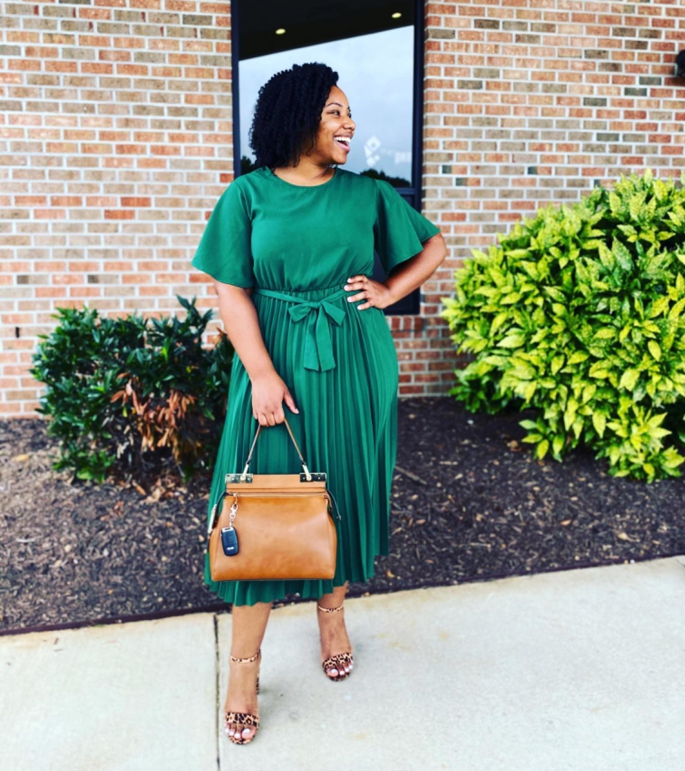 A customer review photo of them in the dress in green
