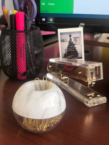 a reviewer photo of the paper clip holder sitting on a desk