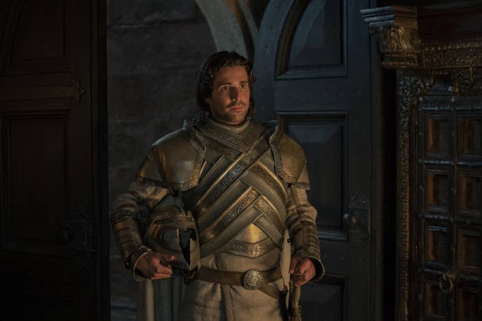 Ser Criston stands in a doorway wearing his uniform