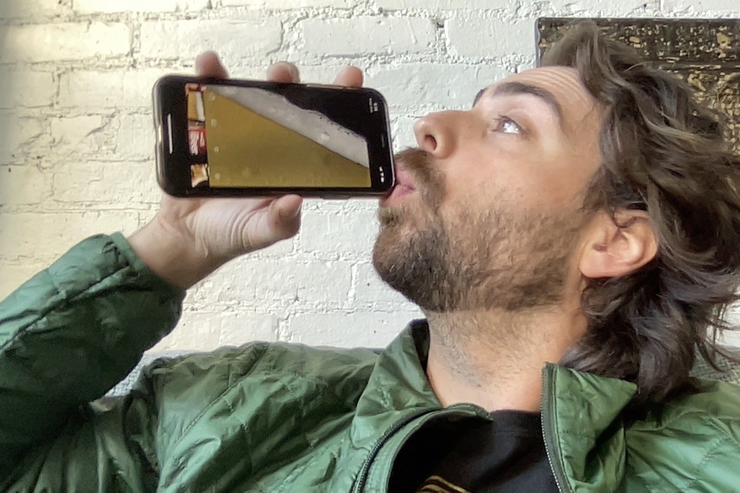 a man drinking out of a fake beer app