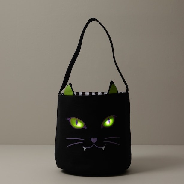 a black cat tote with glowing eyes