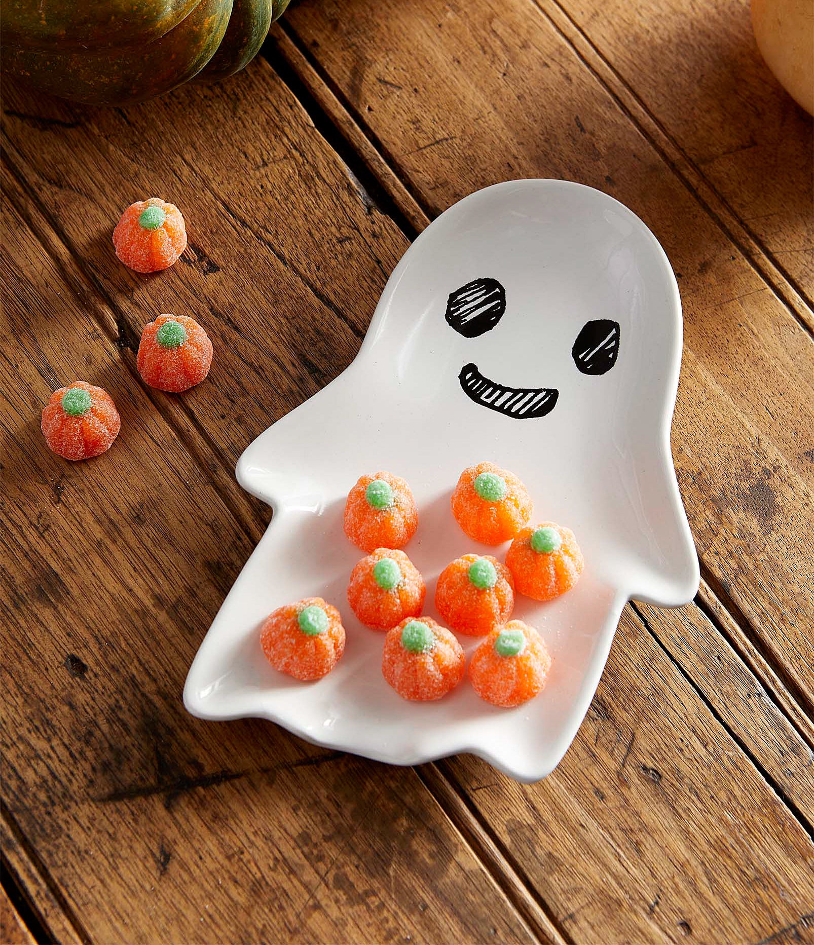 a ghost-shaped plate with candy corn on it