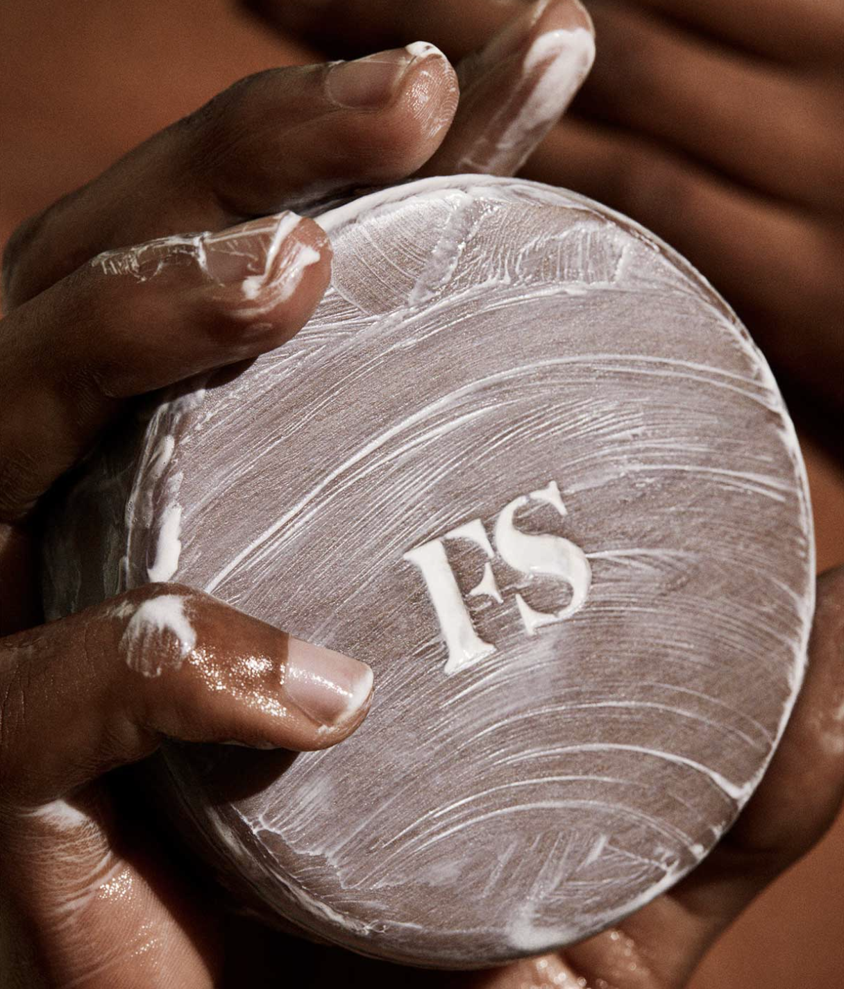 A person holding the cleansing bar