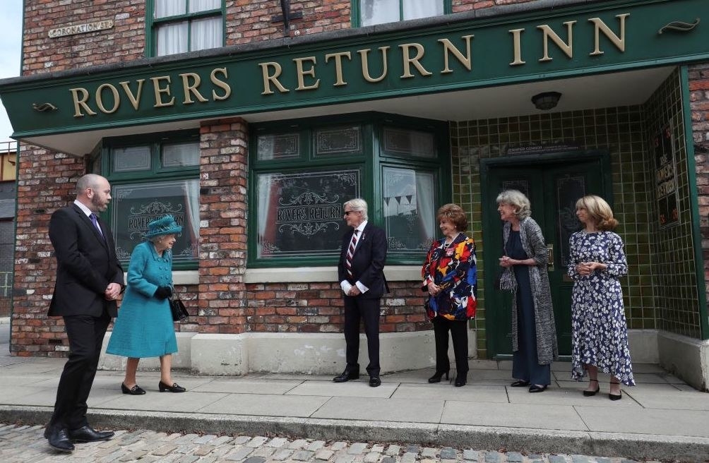 The queen on the set of coronation street outside rovers returns pub