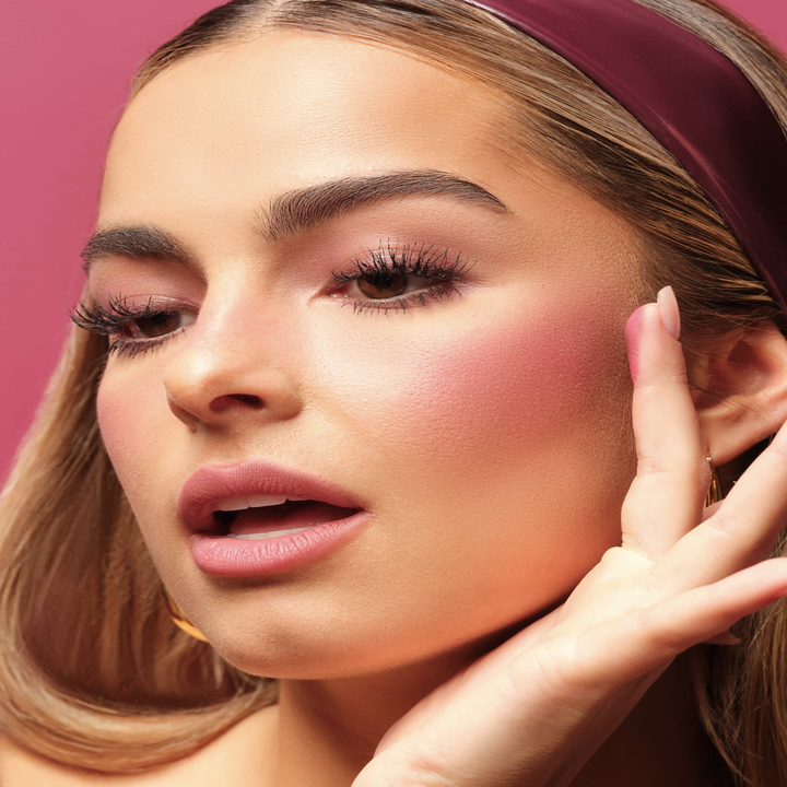 Addison Rae applying the blush to her cheek