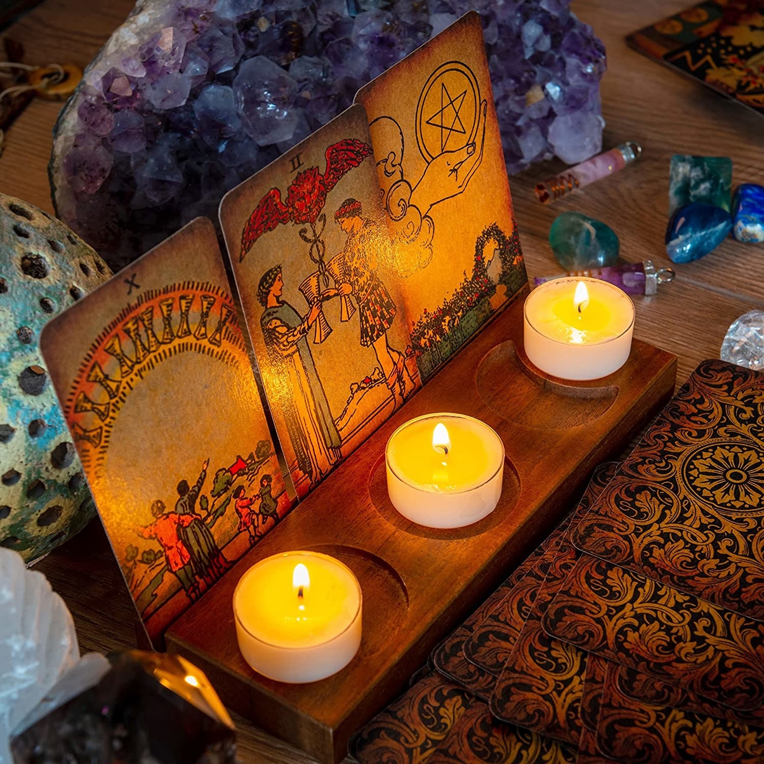 a wood tarot card stand with three candles on it