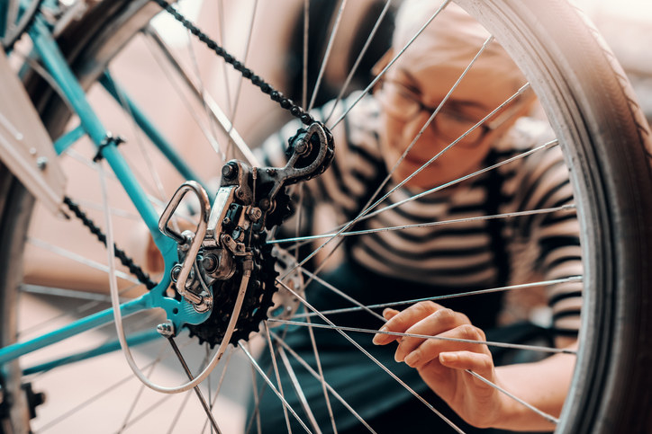 a person fixing a bike wheel
