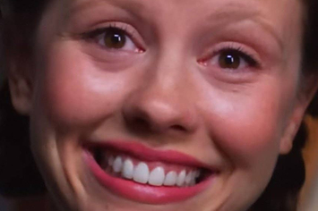Mia goth smiling intensely