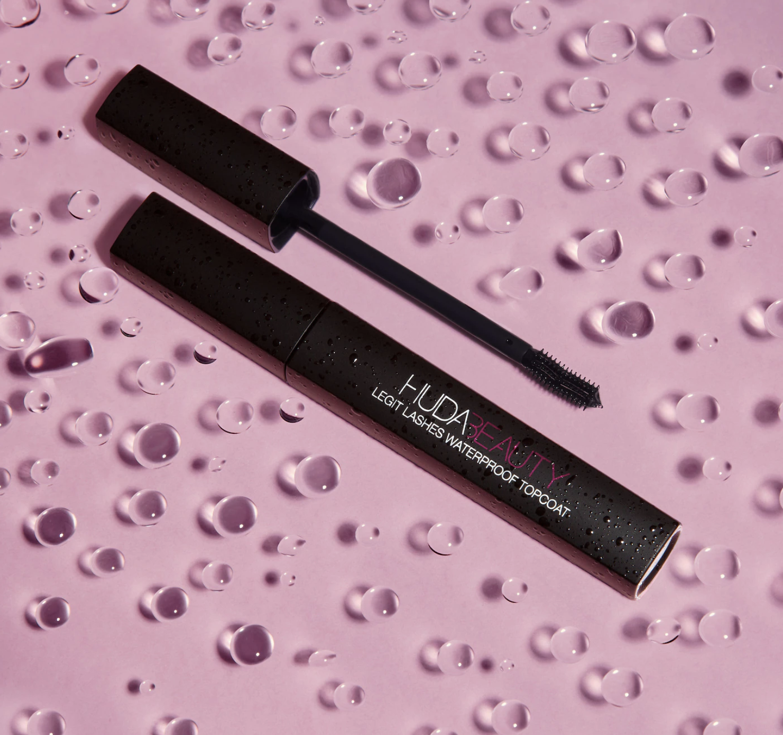 The mascara top coat surrounded by droplets of water