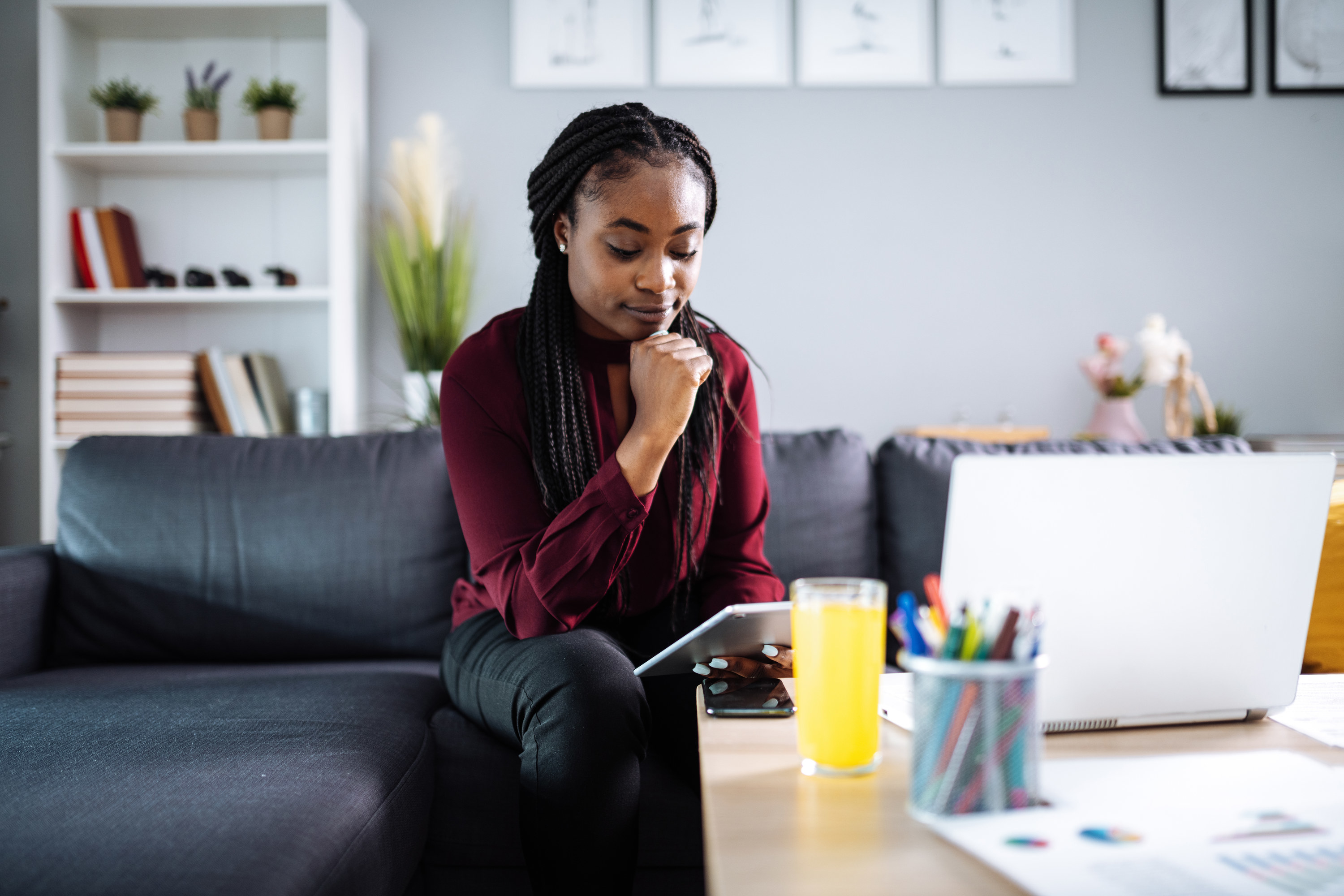 Woman looking at her tablet from home