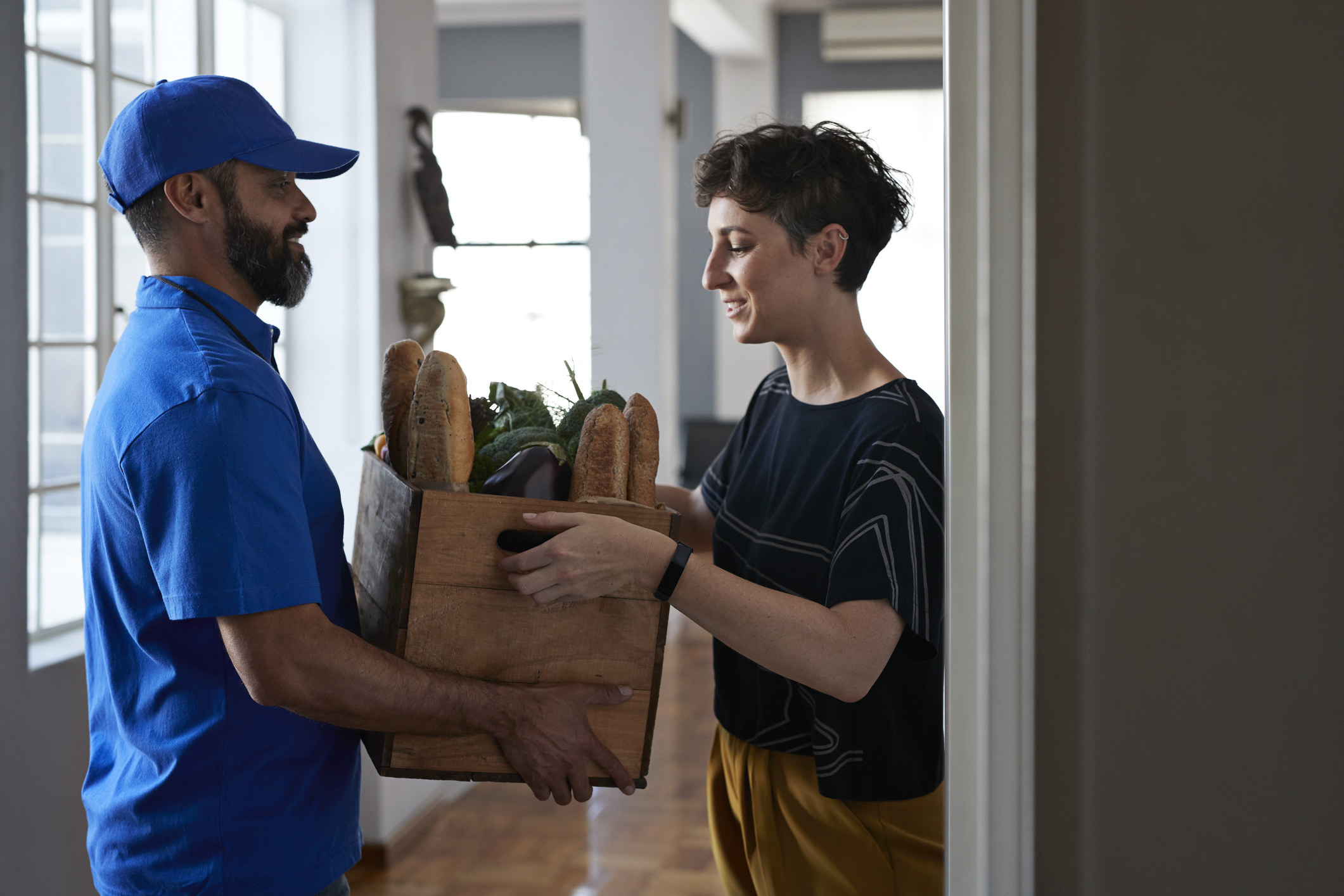 Person delivering a box of groceries